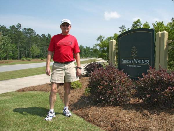 Ed Fore standing by entrance sign of the fitness & Wellness center at Brunswick Forest