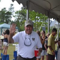 Man under canopy waving