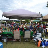 Groups of people eating under canopies