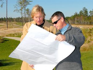 Course Designer Tim Cate looking at course plans with someone