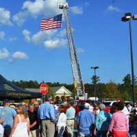 American flag raised on a fire truck ladder