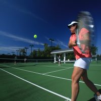 Women hitting a tennis ball