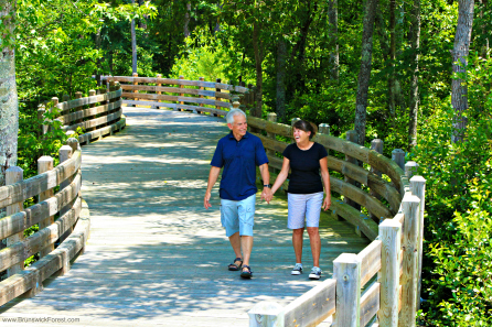 COUPLE WALKING ON BRIDGE