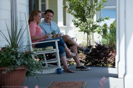 Couple sitting on porch at Brunswick Forest