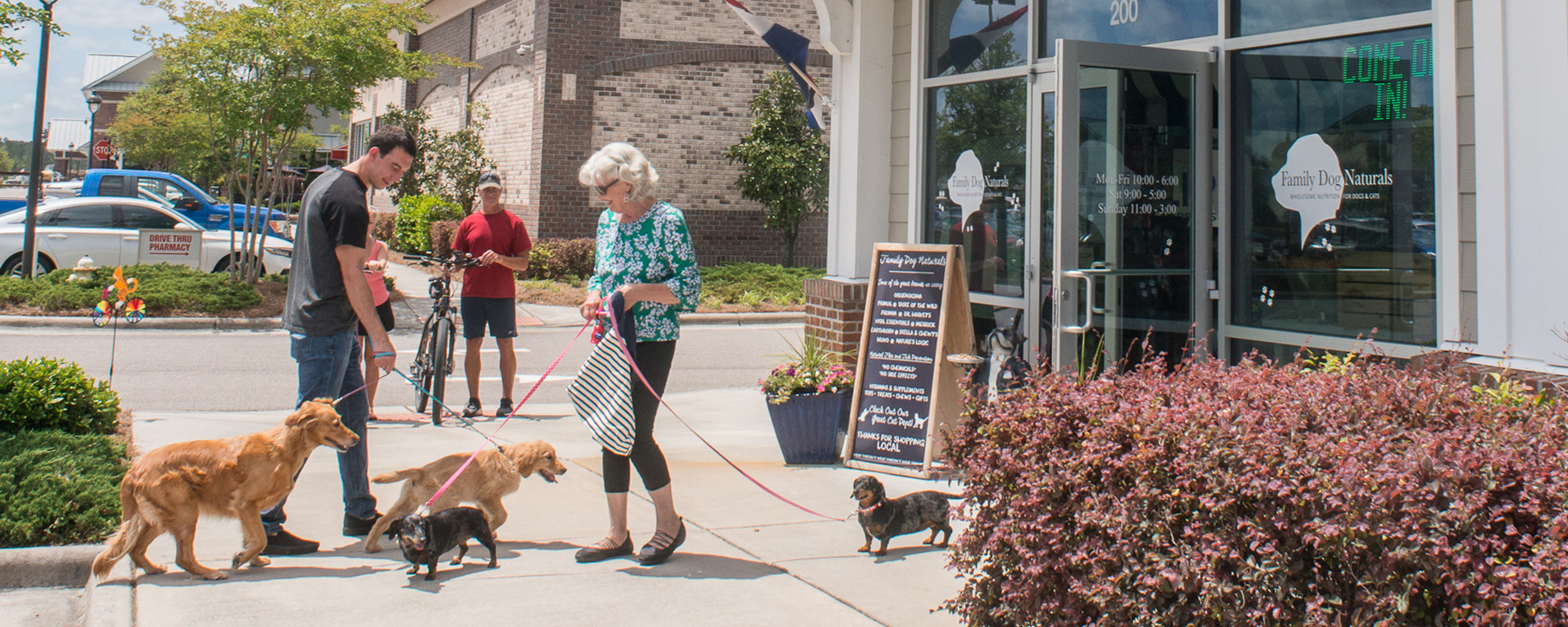 Dogs and their owners outside of Family Dog Naturals