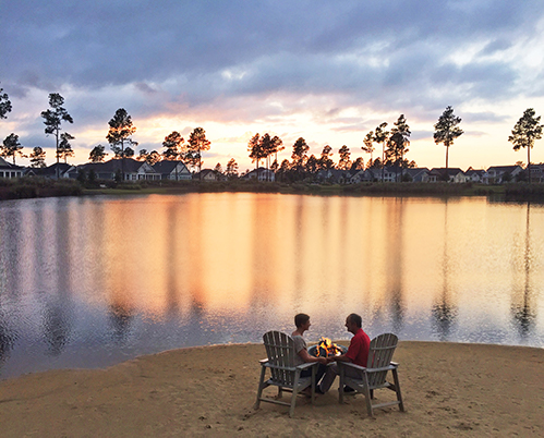 Couple enjoying Hammock Lake by a fire pit around sunset