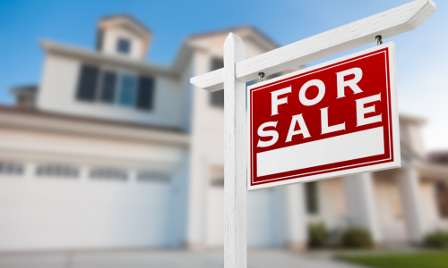 A for sale sign in front of a home